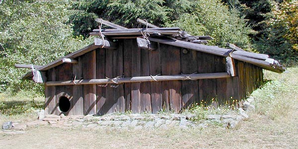 [Photo of Yurok plank house]
